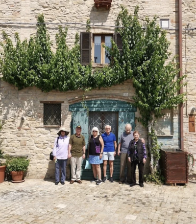 A group of people standing outside an old Italian building photo On the Italian on Tour’s 10 day Italy Uncorked Small Group Tour